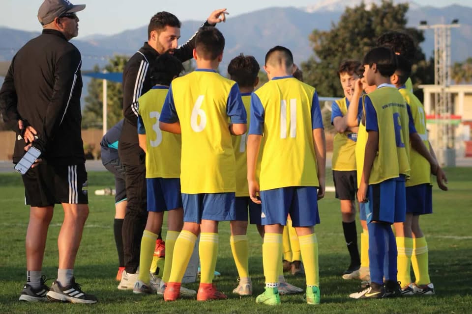 Coach giving tactical instructions to youth team